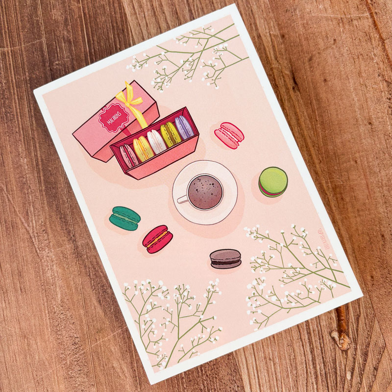 Illustration de macarons multicolores sur fond pastel, branches de cerisiers en fleurs, ambiance printanière et gourmande.